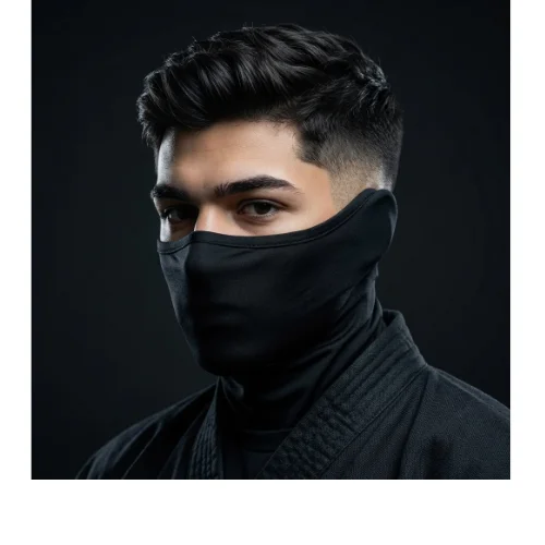 Man with thick hair styled in a ninja-inspired look on top and a clean low taper fade on the sides, creating a bold and modern hairstyle.