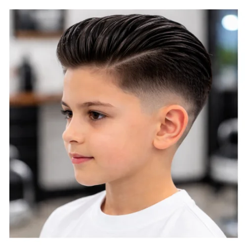 Low taper fade haircut for kids with slick back hair, featuring clean faded sides and a smooth combed-back top for a neat classic look