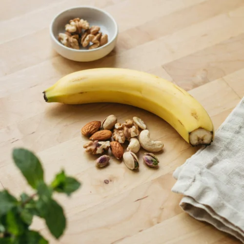 A healthy Day 3 snack with mixed nuts, dried fruits, and fresh berries displayed on a clean white background.